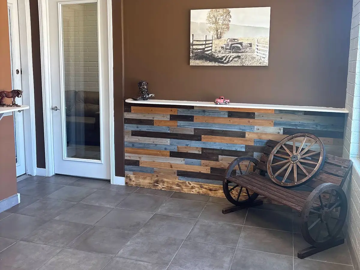 Reception area with a reclaimed wood desk front and a wagon wheel display